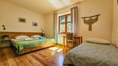 a bedroom with two beds and a window at Willa Rudy in Stronie Śląskie
