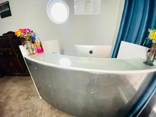a bathroom with a tub with flowers in vases at Great Choice BnB in Goodwood