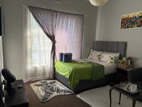 a bedroom with a bed and a window with a zebra rug at Great Choice BnB in Goodwood