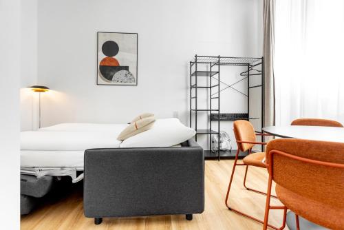 a bedroom with a bed and a table and chairs at Global Living Chemnitz Rosenhof in Chemnitz