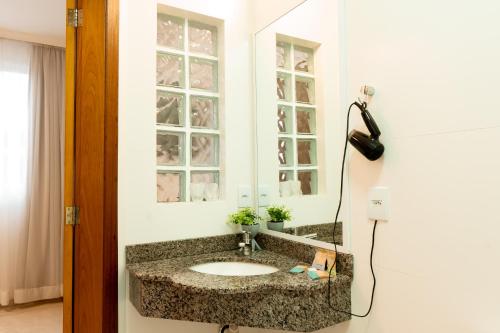 a bathroom with a sink and a mirror at Hotel Appel in Santa Maria