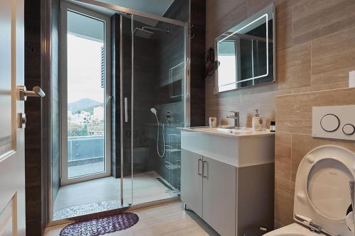 a bathroom with a shower and a toilet at Skyline Sunset in Bečići