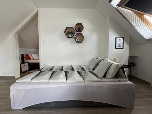 a bedroom with a large white bed in a room at Andrea Apartmanok in Hajdúszoboszló