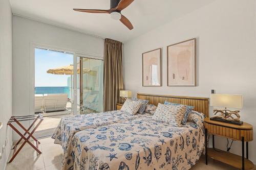 a bedroom with a bed with a view of the ocean at Callao Beach 8 in Arrieta