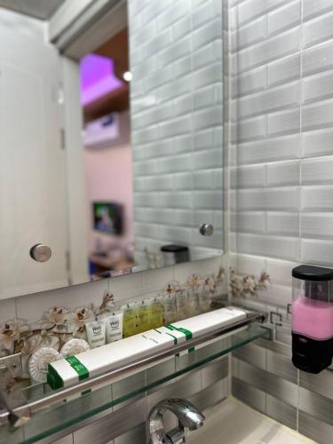a bathroom with a sink and a mirror at The Ambassador Hotel Dhaka in Dhaka