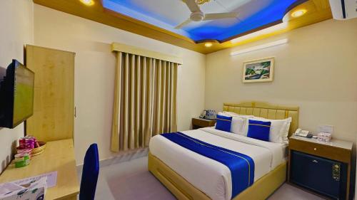 a hotel room with a bed and a tv at The Ambassador Hotel Dhaka in Dhaka