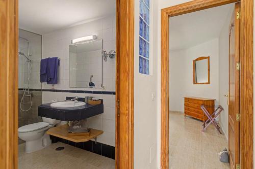 a bathroom with a sink and a toilet at Callao Beach 5 in Arrieta