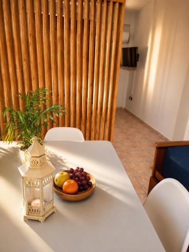 a plate of fruit on a table with a lantern at Rouchotas Studios by Viktor 1rst Floor in Argostoli