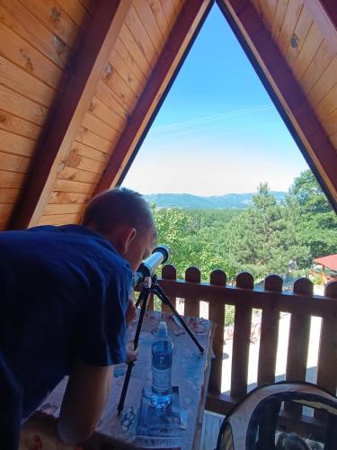 a young boy standing on a table with a bottle of water at Seoski Turizam Feniks apartman Davidovi Psalmi in Kosjeric