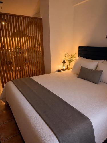 a bedroom with a large white bed and a window at Rouchotas Studios by Viktor 1rst Floor in Argostoli