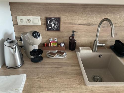a kitchen counter with a sink and a coffee maker at Ivanka Apartments in Ivanka pri Dunaji