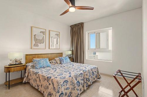 a bedroom with a bed and a ceiling fan at Callao Beach 10 in Arrieta