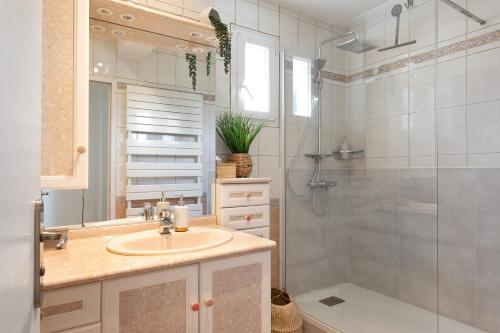 a bathroom with a sink and a shower at La Parenthèse Paimpolaise in Paimpol