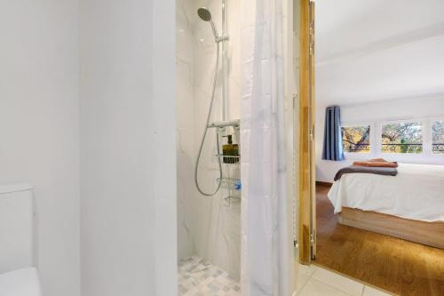 a bathroom with a shower and a bed and a mirror at Villa Rêve d'Azur in Grasse