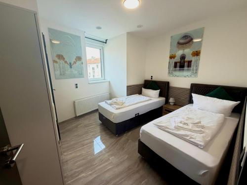 a room with two beds and a mirror at Hotel Montenegro in Worms