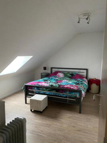 a bedroom with a bed in a attic at Maison de campagne in Chièvres