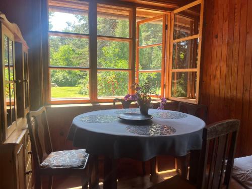 a table in a room with a window at Ūbelītes in Pērkone