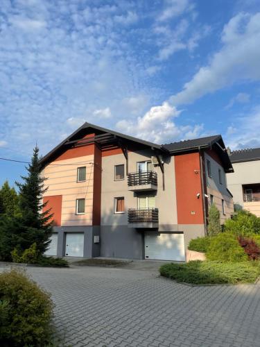 a building with two garage doors on a street at Apartament Słoneczny 31 in Czechowice-Dziedzice