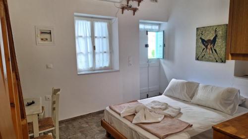 a bedroom with a bed and a window at Cavo Paradise Studio Cyclades in Kimolos