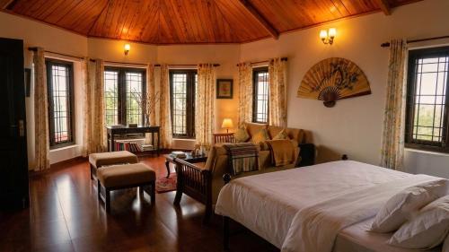 a bedroom with a bed and a living room at Ivy Hill in Yedapalli