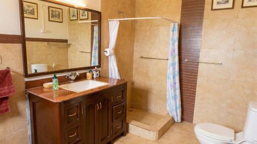 a bathroom with a shower and a sink and a toilet at Ivy Hill in Yedapalli