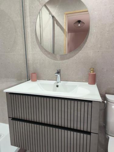 a bathroom with a sink and a mirror at Chambre d'hôte in Maligny