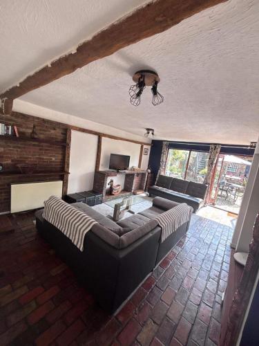 a living room with a couch and a table at Sleeps 5 with in picturesque Chiddingly in Lewes