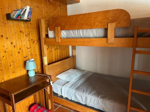 a bedroom with two bunk beds and a desk at Casa do Adro in Viana do Castelo