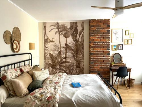a bedroom with a bed and a wall mural at Maison Familiale in Reugny