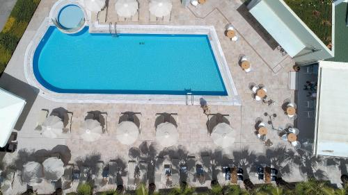 an overhead view of a swimming pool with a bunch of chairs at Angela Suites Boutique Hotel in Sisi