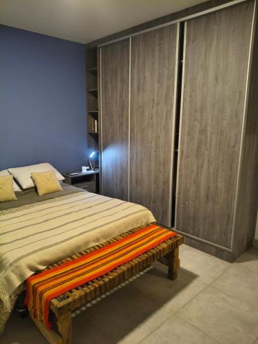 a bedroom with a bed with an orange blanket at Finca Las Marías in Cardozos