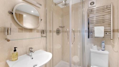 a bathroom with a shower and a sink and a toilet at 1 Bed in Hawkshead oc-lr067 in Hawkshead