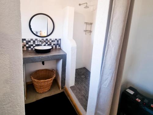 a bathroom with a sink and a mirror at Oudam Cottage in Carnarvon