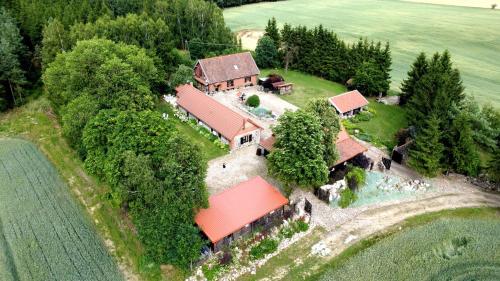 an aerial view of a house on an island at Siedlisko Żywe Kamienie in Naguszewo