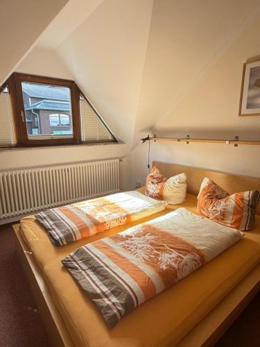 a large bed in a room with a window at Haus Oberwiesenthal in Kurort Oberwiesenthal