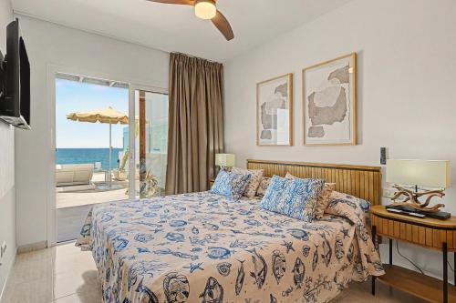 a bedroom with a bed with a view of the ocean at Callao Beach 6 in Arrieta