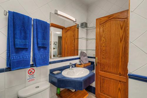a bathroom with a sink and a toilet and a mirror at Callao Beach 6 in Arrieta