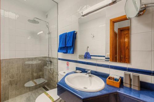 a bathroom with a sink and a mirror and a shower at Callao Beach 7 in Arrieta