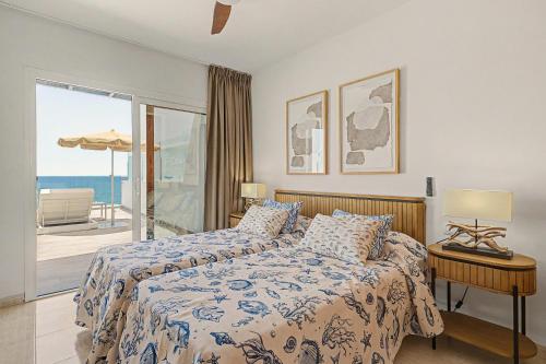 a bedroom with a bed with a view of the ocean at Callao Beach 7 in Arrieta