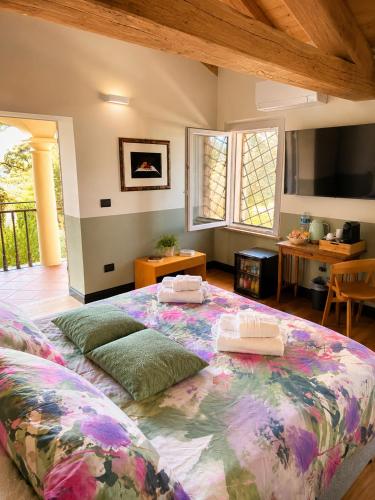 a bedroom with a large bed with two pillows on it at B e B Villa Livia in Rolo