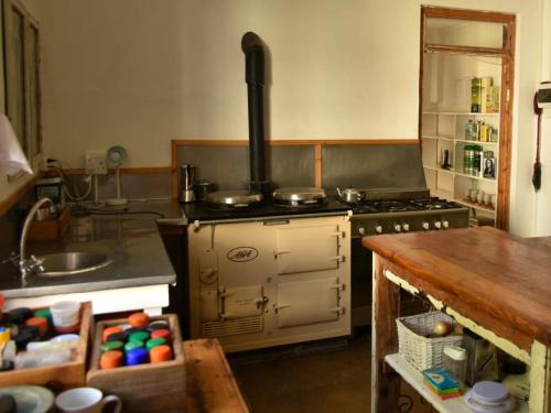 a kitchen with an old stove and a sink at Konka Guest Farm in Carnarvon