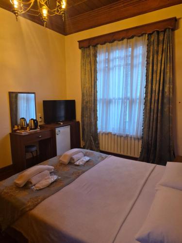a bedroom with a bed with two towels on it at Ali Paşa Konağı Sarıyer in Sarıyer
