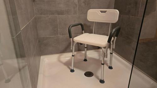 a stool sitting in a bath tub in a bathroom at Big Green in Haverhill
