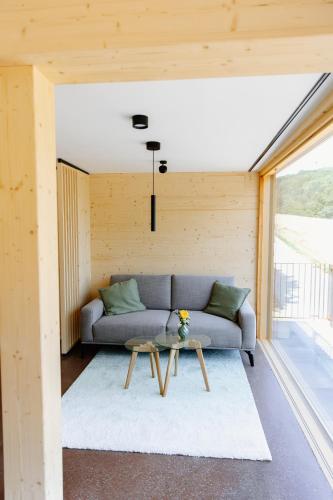 a living room with a couch and a table at OFF Living Charlet in Pirching am Traubenberg