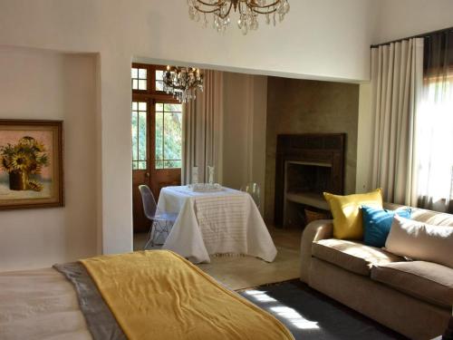 a living room with a table and a couch at Konka Guest Farm in Carnarvon