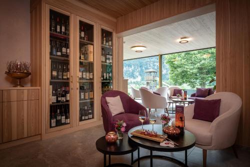 a room with two chairs and a table with wine glasses at Salzano Basic Rooms Interlaken in Interlaken