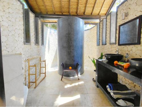 a kitchen with a large stove in a room at Villa Terang Bulan - luxury private beachfront villa in Pengastulan