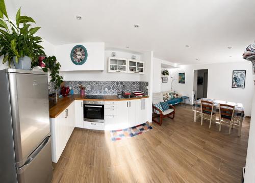 a kitchen with a refrigerator and a dining room at Entre Mer et Montagnes in Céret