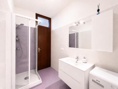 a white bathroom with a sink and a shower at Bella Vita Stays Easy in Sondrio