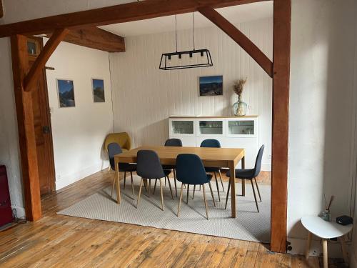 a dining room with a wooden table and chairs at Sporting Pyrenées House in Vicdessos